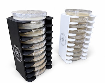 May include: Two vertical storage racks for petri dishes, one black and one white, each featuring ten horizontal slots. The side panels display a circular logo with the text MycoFix. The racks hold multiple clear plastic petri dishes stacked.
