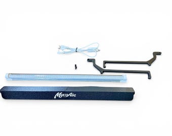 May include: A MycoAir branded black rectangular housing unit, a long LED light bar with a light blue frame, two black L-shaped metal brackets, a small black screw, and a light blue power cord with a plug, all arranged on a white surface.