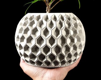 May include: A set of three ceramic mugs with a speckled, matte finish. The mugs are in shades of cream, light gray, and dark gray. Each mug has a simple, minimalist design, perfect for coffee or tea.