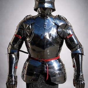 May include: A polished, reflective suit of armor, complete with a helmet, chest plate, and articulated limbs. The armor features a red belt and accents, and is displayed on a stand. The overall design is reminiscent of medieval knight armor.