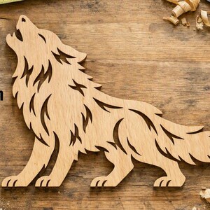May include: A light brown wooden cutout of a wolf howling, featuring intricate cut-out details in the fur. A vertical arrow and the text 12 in indicate the height of the wolf figure, which is measured at 12 inches from top to bottom.