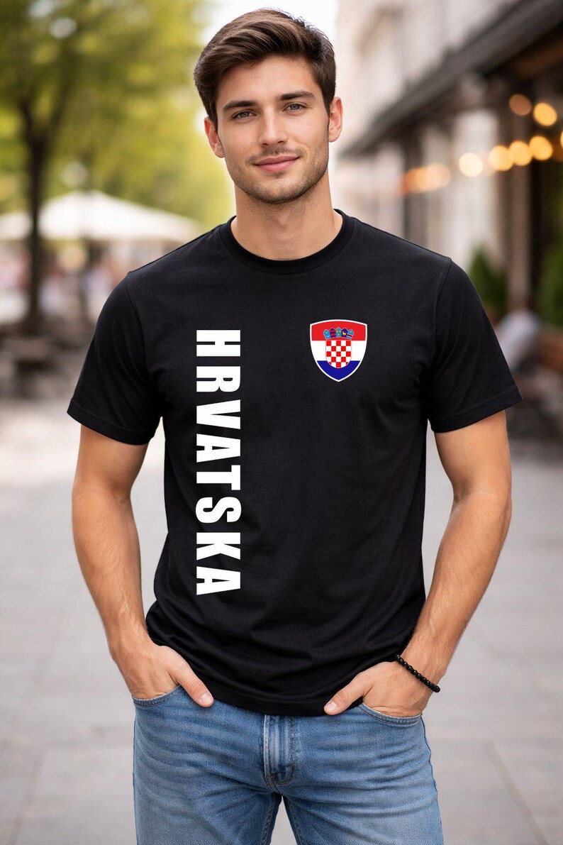 May include: Black t-shirt with the word "HRVATSKA" in white vertical text on the left side. A Croatian coat of arms is on the right chest. The shirt is short-sleeved.