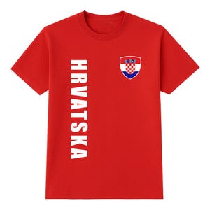 May include: A red t-shirt with the word "HRVATSKA" printed vertically in white on the left side. A Croatian coat of arms is on the right chest area.
