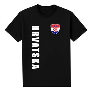 May include: Black t-shirt with the word "HRVATSKA" printed vertically in white on the left side. A Croatian coat of arms is on the right chest. The coat of arms is a shield with a red and white checkered pattern.