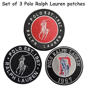 May include: A set of 3 circular Polo Ralph Lauren patches. The top patch has a red center with a white polo player logo and black border. The bottom left is black with a white logo. The bottom right is grey with a red letter P and blue logo.