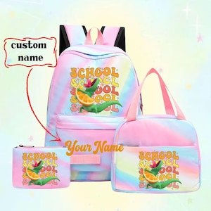 May include: A three-piece school set with a backpack, lunch bag, and pencil case. Each item features a colorful tie-dye pattern and a cartoon alligator holding an orange slice. The text "SCHOOL" is printed on each item.