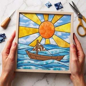 May include: A square framed art piece featuring a stylized scene of a brown sailboat on blue wavy water under a bright orange sun with yellow rays against a blue sky with white clouds. The artwork uses a segmented, stained-glass style design.