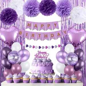 May include: A party decoration set featuring purple and white paper pom-poms, a purple banner with gold text reading HAPPY BIRTHDAY, two heart-shaped foil balloons, assorted purple and white balloons, and a cake with a Happy Birthday topper.