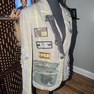 May include: A blazer featuring a black and white houndstooth pattern with neon green accents. It is decorated with various patches, including one that reads "I'M NOT PERFECT BUT I'M A LIMITED EDITION" and another that says "EXPENSIVE".