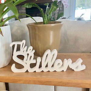 May include: A set of three ceramic mugs with a speckled, matte finish in cream, light grey, and dark grey. Each mug has a simple, minimalist design and a rounded handle.