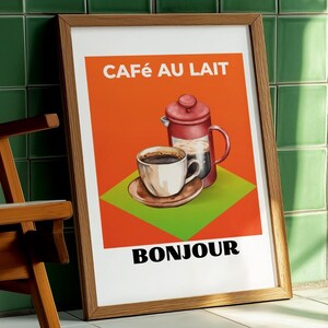 May include: Framed art print with a vintage coffee theme. The artwork features a cup of coffee, a French press, and the words "CAFÉ AU LAIT" and "BONJOUR" on an orange and green background. The frame is made of wood.