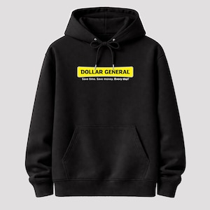 May include: Black hooded sweatshirt with a front pocket and drawstring. The front features a yellow rectangle with the words "DOLLAR GENERAL" in white, and the tagline "Save time. Save money. Every day!"