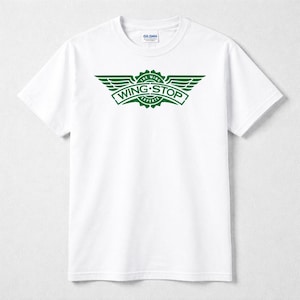 May include: A white short-sleeve t-shirt featuring a dark green graphic on the chest. The graphic displays a stylized emblem with wings and the text WING STOP THE WING EXPERTS. The shirt has a crew neckline and a Gildan brand label at the inner neck.