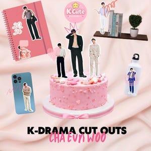 May include: A pink cake with cutouts of K-Drama actors, a pink notebook, a blue phone case, and a white water bottle. The cake is decorated with pink sprinkles and heart-shaped candies. The notebook has the numbers "20 26" on it. The text "K-DRAMA CUT OUTS CHA EUN WOO" is at the bottom.