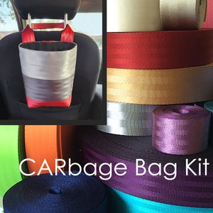 May include: A DIY car trash bag kit with various colors of webbing. The kit includes a pre-made trash bag with a gray, black, and red striped design. The bag is hanging from the headrest of a car seat.