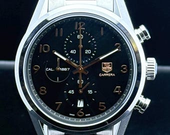 Reloj de pulsera vintage Tag Heuer Carrera Calibre 1887 Cronógrafo de cuarzo con esfera negra, caja y brazalete de acero inoxidable, fecha y segundero para hombre.
