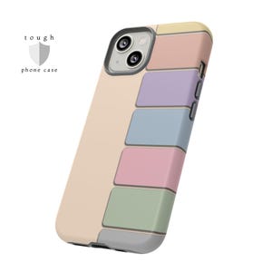 May include: A colorful phone case with a pastel color block design. The case features a light beige background with rectangular blocks in yellow, pink, purple, blue, and green. The text "tough phone case" is printed on the left side.