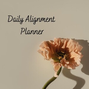 May include: A peach-colored flower with a green stem and the text "Daily Alignment Planner" in black script. The flower is in full bloom, with delicate petals and a dark center. The background is a neutral beige.