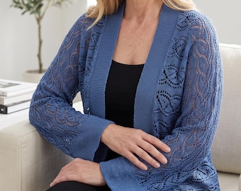 May include: A blue open-front cardigan featuring a delicate, intricate lace-like knit pattern throughout the sleeves and body, complemented by solid ribbed trim along the front opening and cuffs, worn over a simple black top.