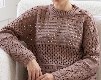 May include: A mauve long-sleeve knit jumper featuring an openwork crochet pattern, a ribbed crew neckline, and horizontal bands of small, reflective silver sequins across the chest. The garment has a loose fit with cuffed sleeves.
