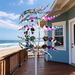 May include: A kinetic wind spinner featuring multiple tiers of iridescent, circular metal discs attached to a central vertical pole. The reflective surfaces display a spectrum of colors including purple, blue, and green, arranged in a spherical structure.