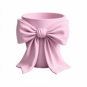 May include: A light pink ceramic planter with a large bow detail. The bow is the same color as the planter and wraps around the front of the pot. The planter has a round opening at the top.