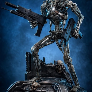 May include: A metallic silver robotic endoskeleton figure with glowing red eyes, holding two black rifles. The figure stands on a dark, circular base featuring human skulls and debris, with a blank rectangular nameplate on the front of the base.