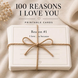 May include: A stack of rectangular white printable cards tied with brown twine in a bow. The top card features the text "Reason #1" and "I love you because" above blank lines and a small heart icon. The header text reads "100 REASONS I LOVE YOU".