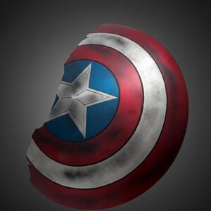 May include: A Captain America shield, featuring a red, white, and blue color scheme. The shield has a central blue circle with a white star, surrounded by red and white concentric rings. The shield has a distressed, battle-worn appearance.