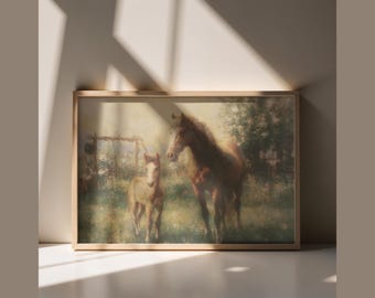 May include: A framed print featuring a serene pastoral scene. Two brown horses stand in a sunlit field, one adult and one foal. The artwork has a soft, painterly quality, with a wooden frame.
