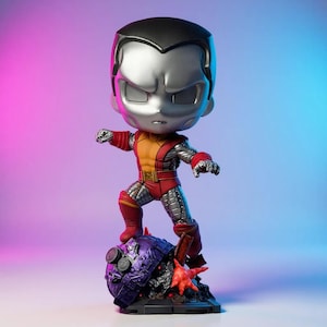 May include: A Colossus figurine stands on a purple and black base with a red star-shaped element. The figurine features a silver head, red and yellow suit, and silver metallic accents. The background gradient transitions from pink to blue.