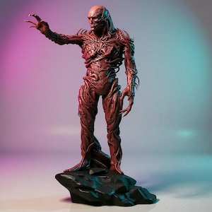 May include: A detailed, reddish-brown figure of a humanoid creature with a textured, organic appearance. The figure stands on a black, rocky base, with one arm outstretched. The background has a gradient of pink and blue hues.