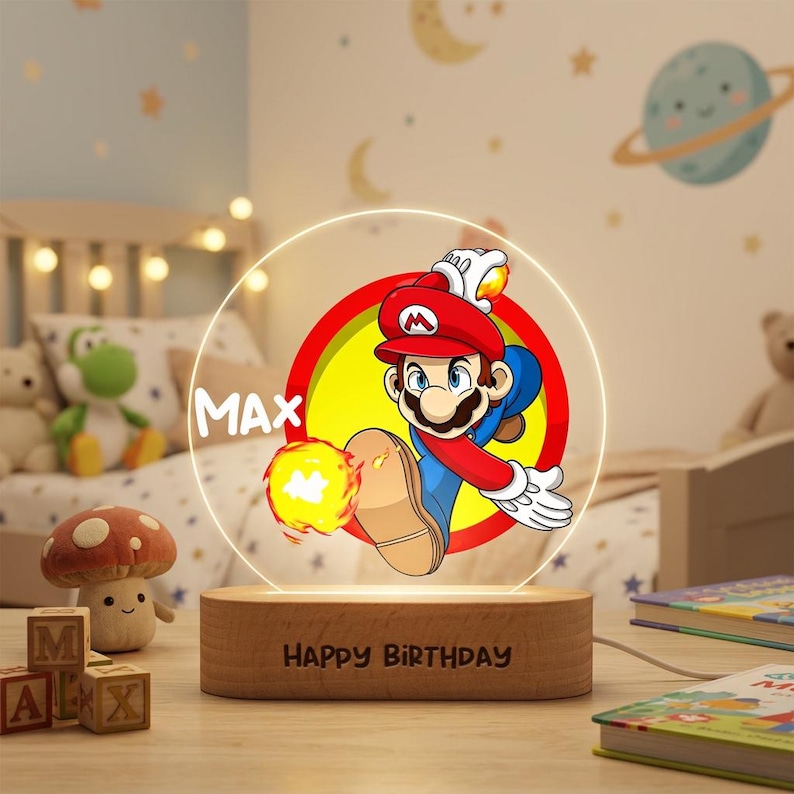 May include: A circular acrylic night light featuring a colorful graphic of Mario throwing a fireball, with the name MAX printed in white. The light is mounted on a rectangular wooden base engraved with the text HAPPY BIRTHDAY.