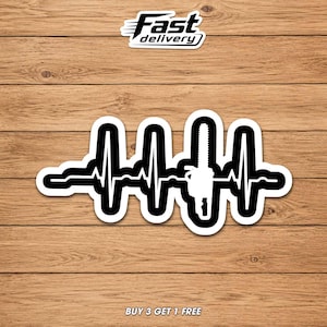 May include: A black and white sticker featuring a chainsaw design integrated into a heartbeat graphic. The sticker has a white border and the text "Fast delivery" and "BUY 3 GET 1 FREE". The sticker is on a wooden background.