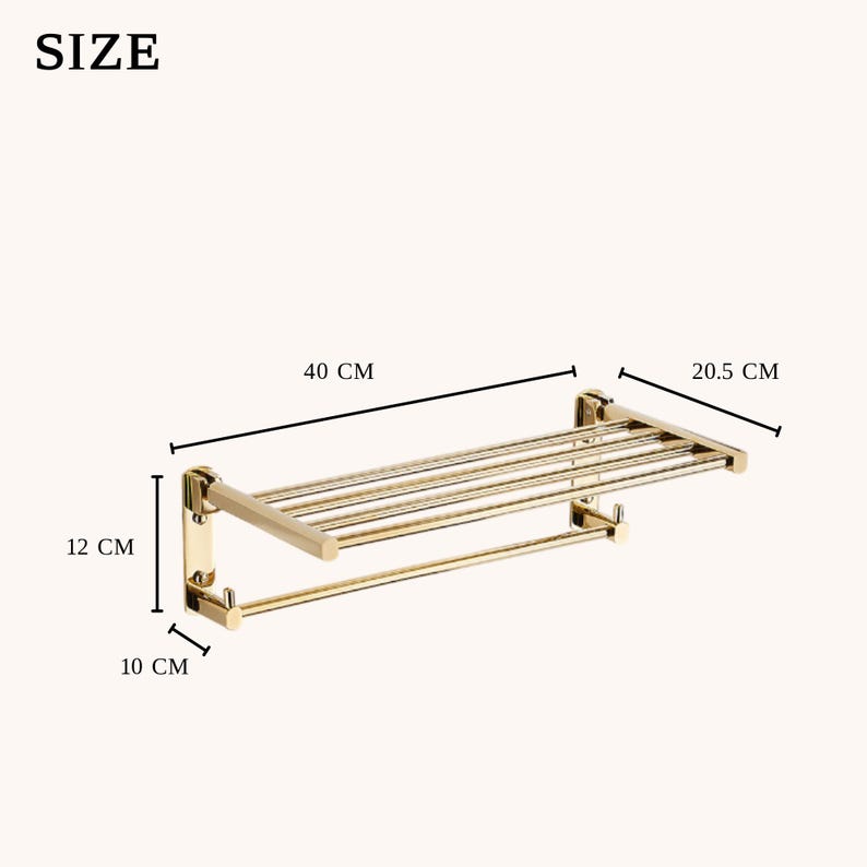 May include: A gold-colored metal towel rack with a shelf and a bar. The rack is 40 cm wide, 20.5 cm deep, and 12 cm high. The bar is 10 cm from the wall. The rack is designed for bathroom use.