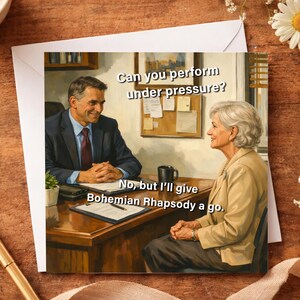 May include: Greeting card with a humorous image of a job interview. The text reads, "Can you perform under pressure?" and the response, "No, but I'll give Bohemian Rhapsody a go."