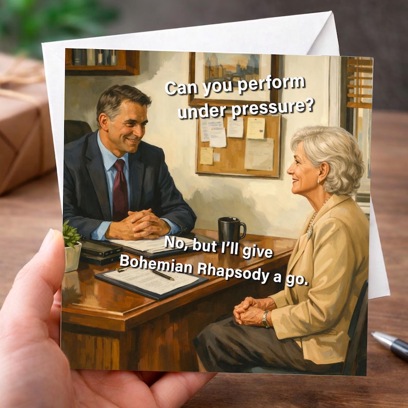 May include: Greeting card featuring a humorous image of two people in an office setting. The text reads, "Can you perform under pressure?" and the response, "No, but I'll give Bohemian Rhapsody a go."