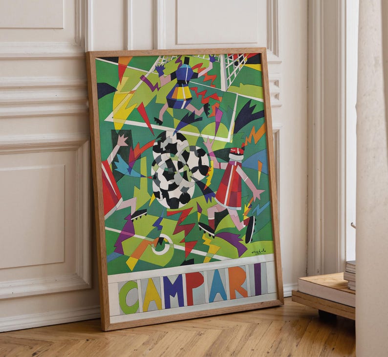 May include: A framed rectangular poster featuring a colorful, abstract soccer scene with geometric players and a soccer ball on a green field. The word CAMPARI is printed in large, multi-colored block letters at the bottom of the artwork.