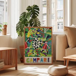 May include: A rectangular framed poster featuring a vibrant, abstract soccer scene with geometric players in red, blue, and yellow uniforms on a green field. The word CAMPARI is printed in large, colorful block letters at the bottom of the artwork.