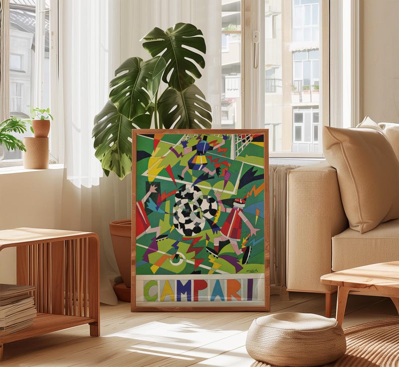 May include: A rectangular framed poster featuring a vibrant, abstract soccer scene with geometric players in red, blue, and yellow uniforms on a green field. The word CAMPARI is printed in large, colorful block letters at the bottom of the artwork.