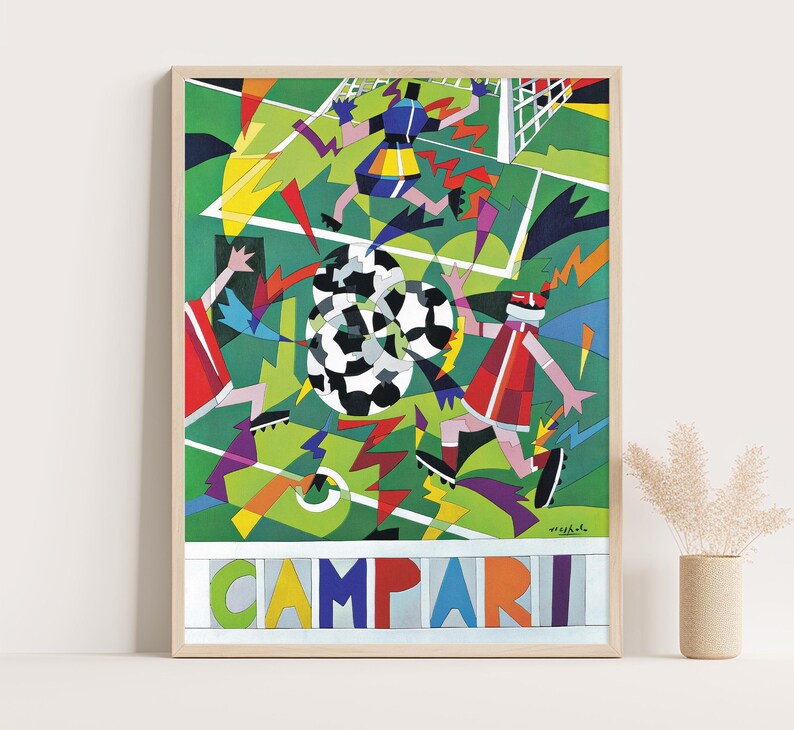 May include: A framed poster featuring a stylized, geometric illustration of a soccer match on a green field. Players in red and blue uniforms compete for a black and white soccer ball. The word CAMPARI is printed in large, colorful letters at the bottom.