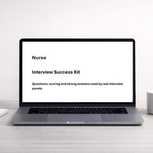 May include: A laptop screen showing "Nurse Interview Success Kit" with text about interview questions and answers. A white mug, a small potted plant, and a notepad are on the desk.