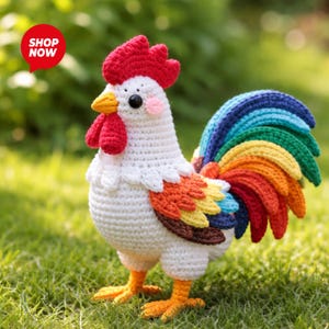 May include: A handmade crochet rooster with a vibrant rainbow tail, red comb and wattle, and orange feet. The rooster is white with colorful accents and the text "SHOP NOW" in a red circle.