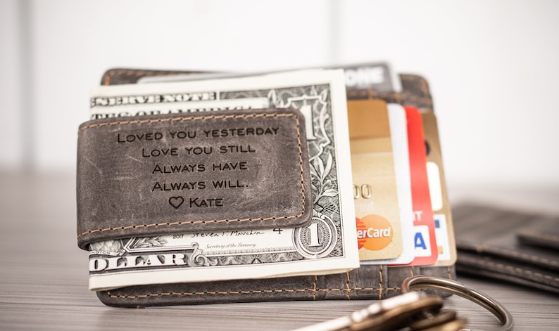 May include: A gray leather wallet with a money clip and a personalized inscription that reads "Loved you yesterday, love you still, always have, always will. Kate".