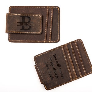 May include: Two brown leather wallets with a money clip. One wallet has the initial "B" and the name "Bishop" engraved on it. The other wallet has the text "You will forever be my always. Love, Katie" engraved on it.