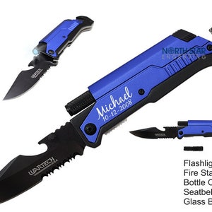 May include: A multi-tool knife with a black blade and blue handle. Features include a flashlight, fire starter, bottle opener, seatbelt cutter, and glass breaker. The knife is engraved with the name "Michael" and the date "10-12-2008".
