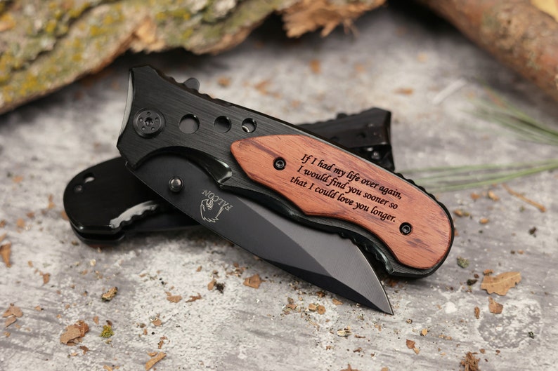 May include: A black folding knife with a wooden handle engraved with the text "If I had my life over again, I would find you sooner so that I could love you longer."