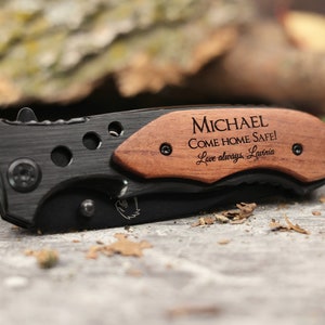 May include: A black pocket knife with a wooden handle engraved with the message "MICHAEL COME HOME SAFE! Love always, Larina."