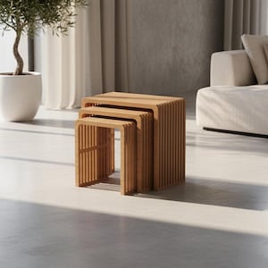 May include: Three wooden nesting tables with a slatted design. The tables are various sizes and are made of light brown wood. The tables are in a modern living room setting with a sofa and a potted plant.