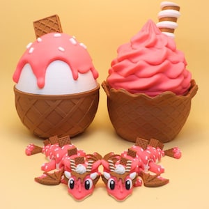 May include: Two ice cream cone-shaped sculptures and two dragon figurines. The ice cream cones have pink ice cream with waffle cone bases. The dragon figurines are pink with white spots and waffle cone accents. The background is a light yellow.